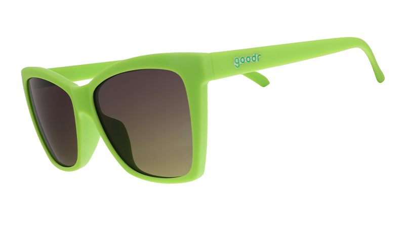 Three-quarter angle view of lime green angled cat-eye sunglasses with non-reflective black gradient lenses.