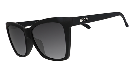 Three-quarter angle view of black angled cat-eye sunglasses with non-reflective black gradient lenses.